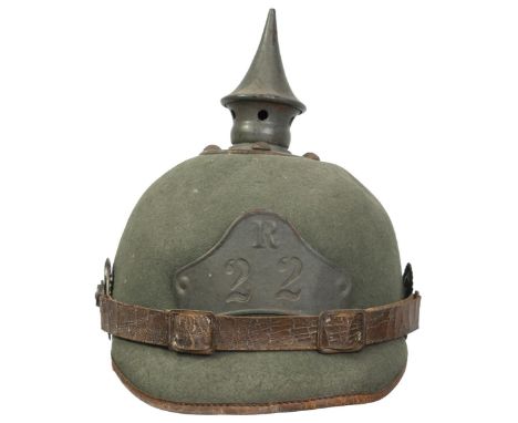 A copy First War 22nd Regiment felt or Ersatz Pickelhaube, the green felt body with grey painted mounts to include embossed R