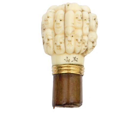 A Japanese Meiji carved ivory walking stick handle signed Gyokuzan, carved with noh masks, 4cm high, together with a Meiji ca