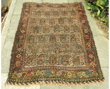 A Turkish Afshar rug, the ivory field with boteh and flower-heads, the madder border with similar decoration within three gua