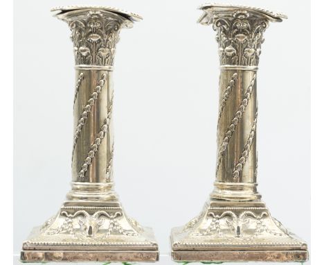 A pair of Edwardian silver candlesticks by William Hutton & Sons, London 1906, the Corinthian capitals with detachable sconce