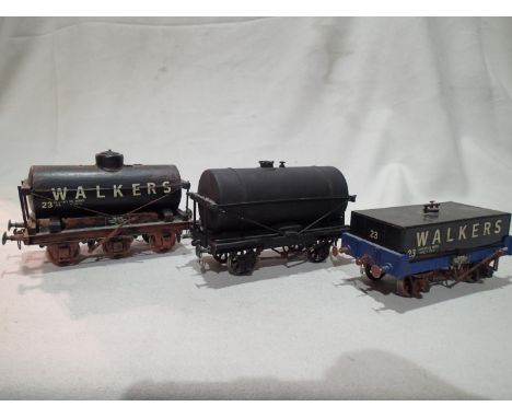 Three O gauge kit built tanker wagons, six wheel walkers, long tank walkers, unnamed black, all finished as well used/weather