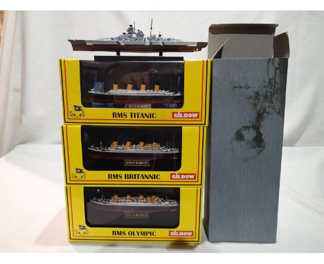 Three Gilbow model ships on display stands, 1/1750 scale, Titanic, Britannic, and Olympic, plus Atlas editions Bismark, all n