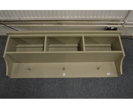 A painted hallway wall shelf / storage unit.