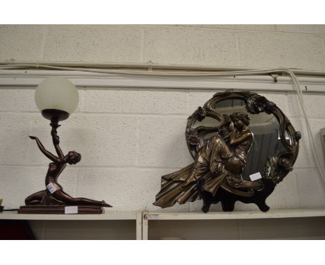 An Art Nouveau style figural lamp and similar mirror.