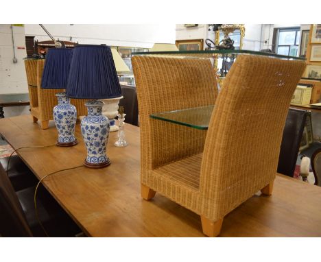 A pair of wicker and glass lamp tables.