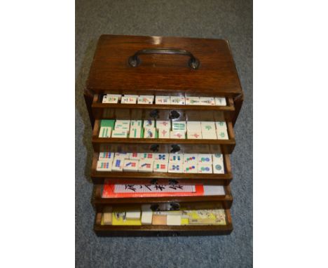 A Chinese Mahjong set in a carved hardwood box.