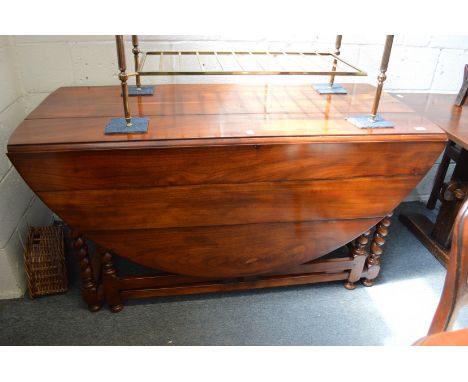 A good large hardwood oval drop-leaf double gate-leg dining table.