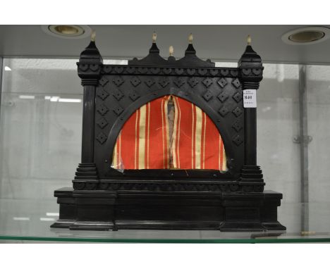 A small Indian ebonised table screen inset with a painting of an erotic scene with pierced silver reverse behind glass.
