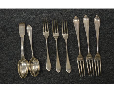 A small group of silver flatware.