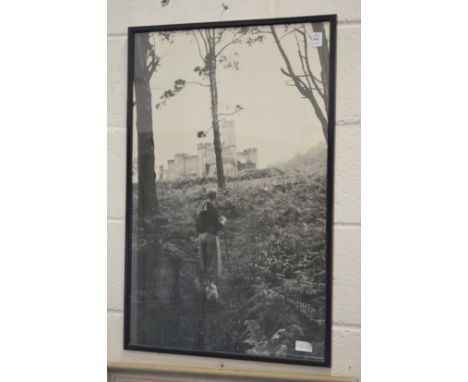 A photographic black and white print, probably depicting a young Prince Philip viewing Balmoral Castle in the distance.