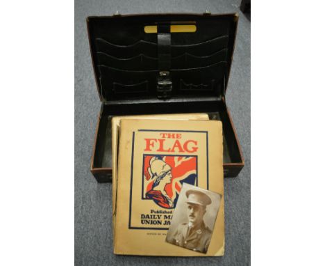 A suitcase containing a book and an enamel photograph.