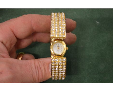 A ladies' decorative bangle wristwatch.