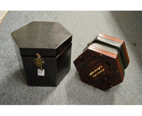 A Wheatstone System mahogany accordion, in a wooden travelling box.