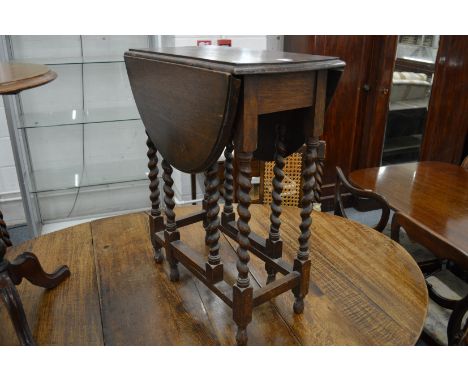 A small oak drop-leaf gate-leg table.