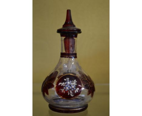 A small enamel decorated glass scent bottle.