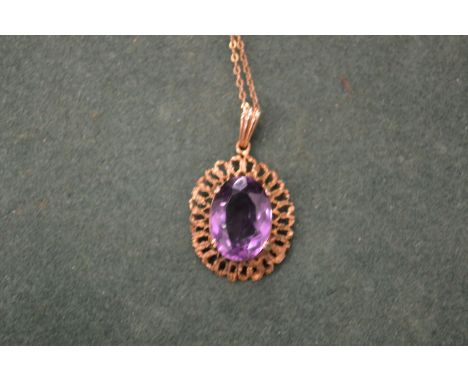 A gold chain with an amethyst pendant.