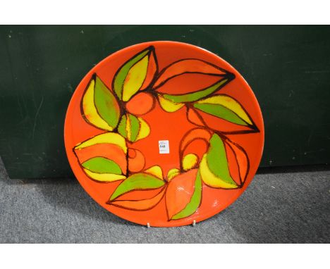 A good large Poole Pottery Delphis charger, orange ground with stylized decoration, shape no. 54, 16ins diameter.