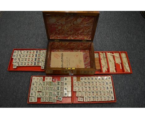 A Mahjong set in a Victorian walnut sewing box.