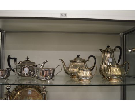 A silver plated three-piece tea service and a plated four-piece tea service with engraved decoration.