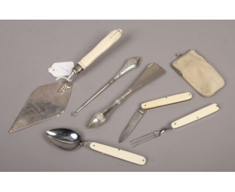 A silver handled button hook and shoe horn, a presentation silver plated trowel with silver collar and a campaign cutlery set