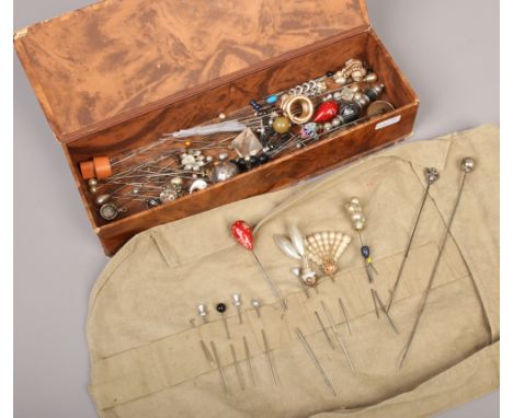 A glove box and collection of assorted vintage hat pins.