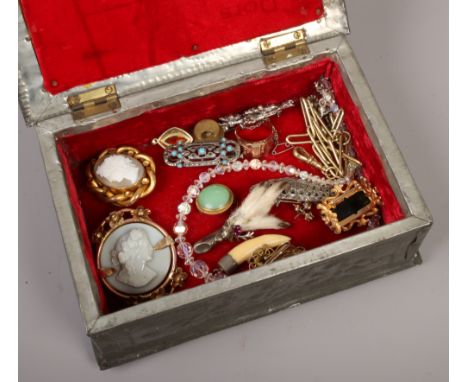 A box of vintage jewellery to include cameo brooches, pheasant foot brooch etc.