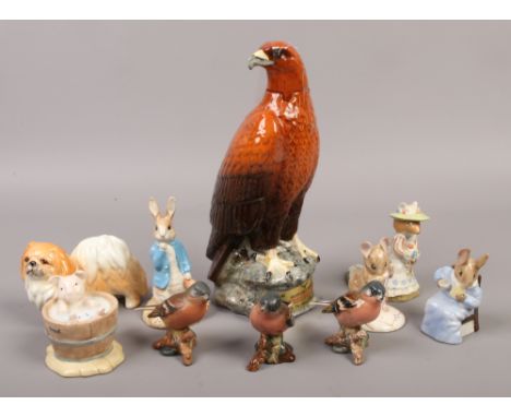 A Beswick Beneagles golden eagle ceramic decanter, along with a collection of Beswick, Royal Doulton and Royal Albert figures