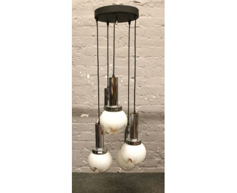 A five branch suspended drop ceiling light with chrome and milchglas globe shaped shades.