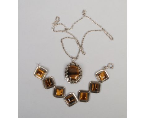 A vintage silver and tigers eye bracelet and a pendant on chain.