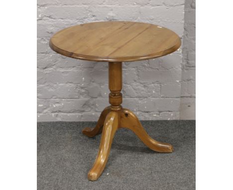 A pine tripod occasional table.