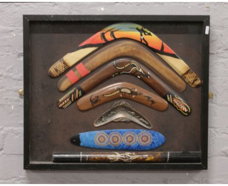 Australian interest; framed decorative boomerangs and a didgeridoo.