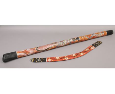 Australian interest; a decorative painted boomerang and a didgeridoo.