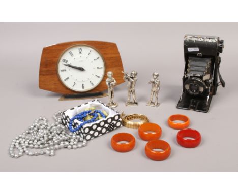 Five 1940s Catalin serviette rings, Metamec mantle clock, costume jewellery, Bellows camera and cast metal figures.