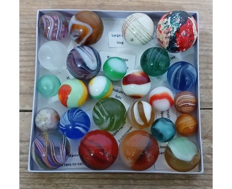 A collection of 25 mainly hand blown glass marbles comprising Joseph Coat, Indian lutz, Master Marble Meteor, MF Christensen,