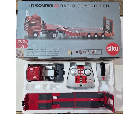 A boxed Siku 1:32 scale radio controlled diecast truck &amp; trailer, in original box.