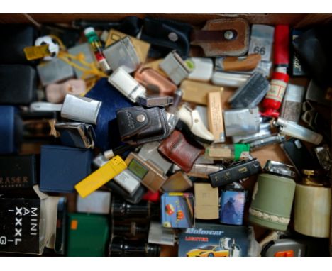 A box of assorted lighters, various manufacturers including Zippo etc.