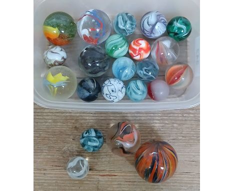 A collection of glass marbles, various designs, ranging in diameter from approximately 22mm to 41mm.Condition (largest marble