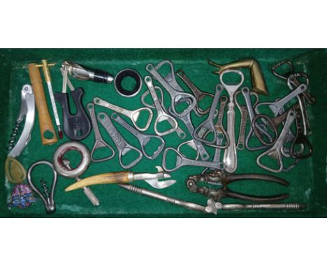 A leather case containing a collection of mainly antique/vintage bottle openers and other collectables.