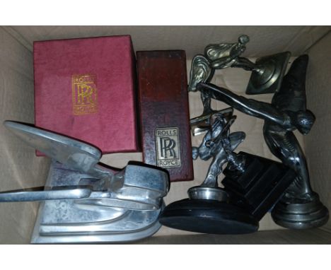 A box of assorted car mascots including Rolls Royce and Bently.