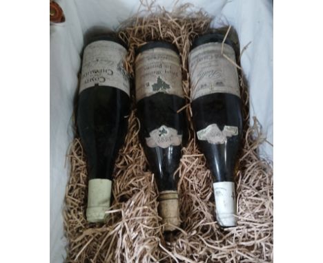 A basket containing three bottles of wine; 1993 Cote de Beaune, 1992 Puligny-Montrachet les Perrieres and 1995 Lupe-Cholet.