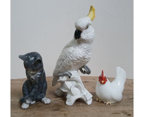 Three porcelain animals comprising a cockatoo designed by Jones for Crown Staffordshire, a Royal Copenhagen cat and a Noritak