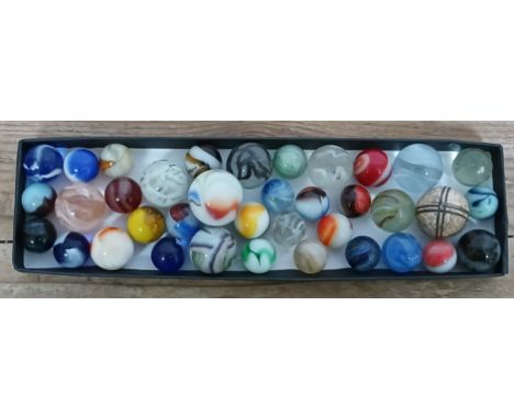 A collection of assorted glass marbles, various designs, including Peltier, Akro agate, German etc, ranging in diameter from 