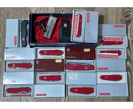 A group of twelve Victorinox Swiss Army multi-tool penknives comprising Lumbar Bag &amp; SwissChamp, Tradesman, Handyman, Rec