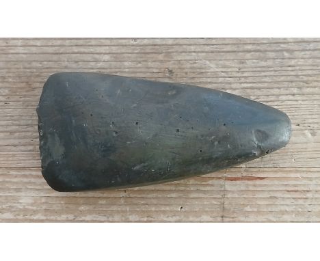A Neolithic stone hand axe, length 11cm.