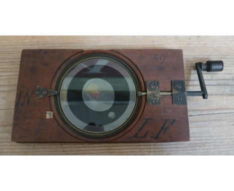 An astronomical orrery mechanical magic lantern slide showing the tidal motions as the moon orbits earth, various inscription