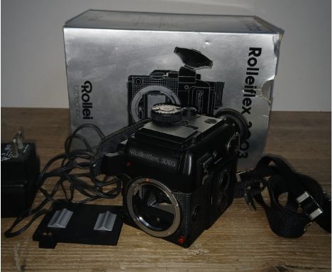 A Rollei fototechnic Rolleiflex 3003 SLR camera body with box and accessories.Condition:- General wear throughout, no sign of
