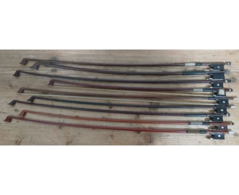 A group of nine assorted violin and cello bows.