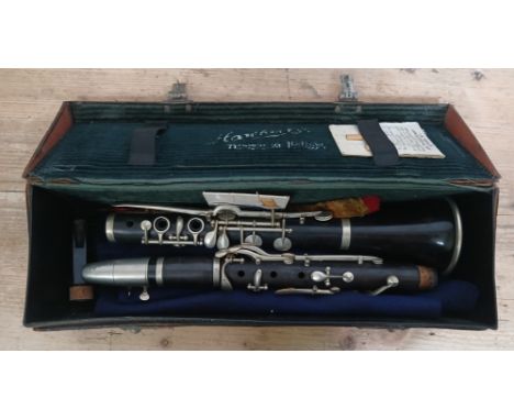 An early 20th century nickel mounted rosewood clarinet, stamped 'E. Foote', with case and accessories.Condition:- General wea