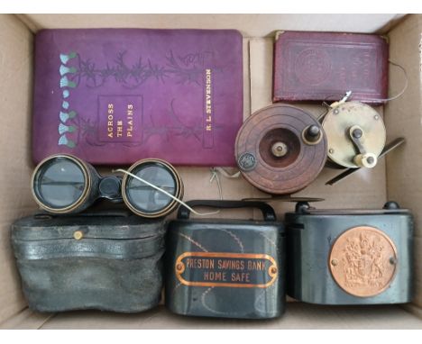 A box of assorted collectables including threee savings banks, two fishing reels, opera glasses etc.