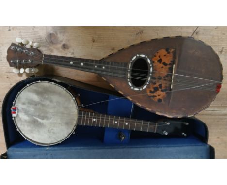 A 4-string banjo and a mandolin labelled ' Ermenegildo Ferrari'.